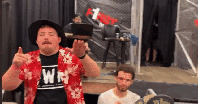a man wearing a shirt that says wm is clapping