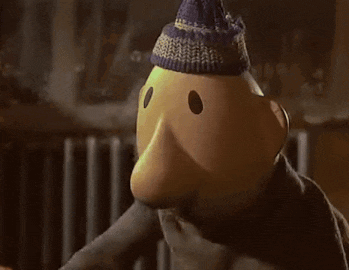 a cartoon character is covering his face with his hand while wearing a hat .