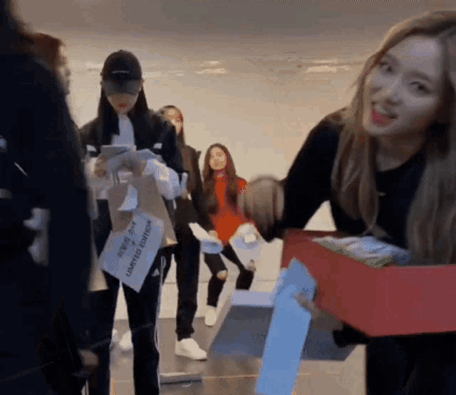 a woman is holding a box with a sign that says limited edition
