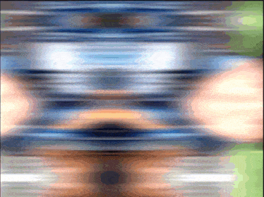 a blurred image of a person 's face with a blue and orange background