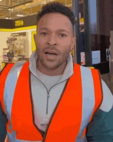 a man wearing an orange vest with the word bully on the front