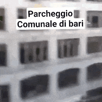 a blurry picture of a building with the words parcheggio communale di bari written on it