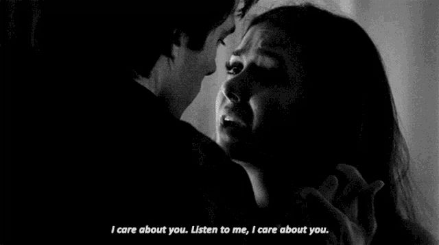 a black and white photo of a man holding a woman 's hand and saying `` i care about you .
