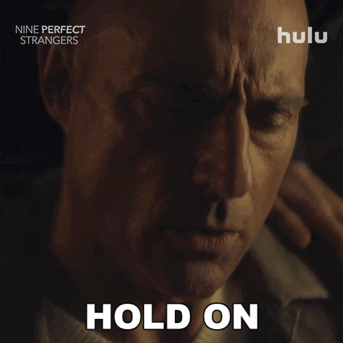 a close up of a man 's face with the words hold on written on the bottom
