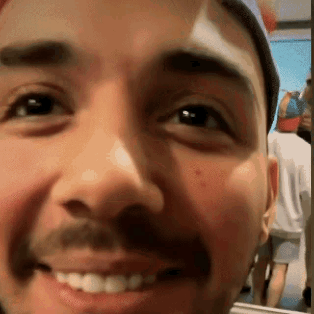 a close up of a man 's face with a mustache