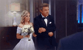 a bride and groom are walking down the aisle