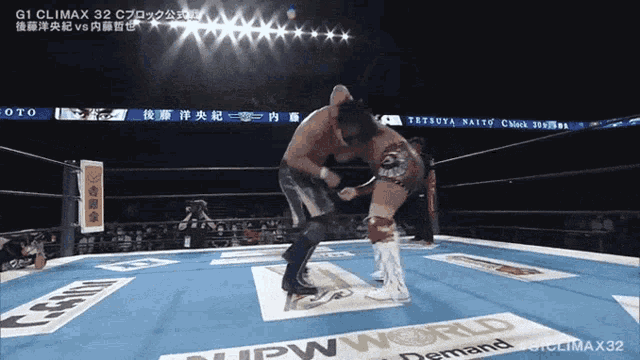 two wrestlers in a ring with a sign that says npw world demand