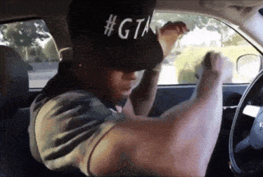 a man wearing a hat that says #gta on it