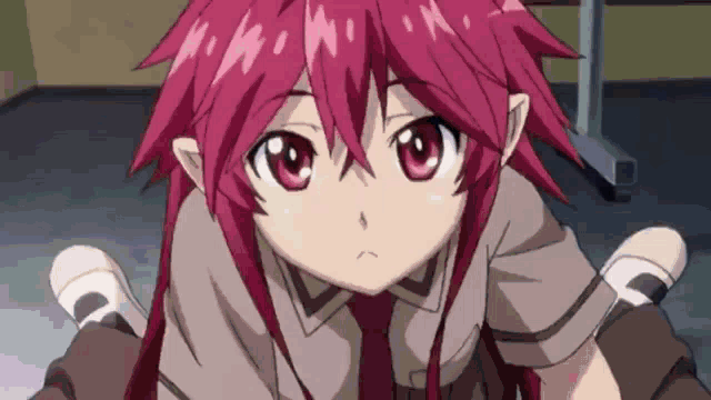 a girl with red hair is sitting on someone 's lap and looking at the camera .