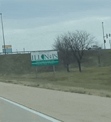 a sign that says illinois is on the side of the road