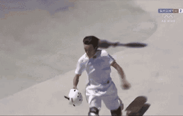 a person riding a skateboard with a helmet on a tv screen that says olympics