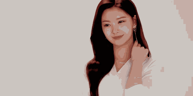 a woman wearing a white shirt and earrings is smiling