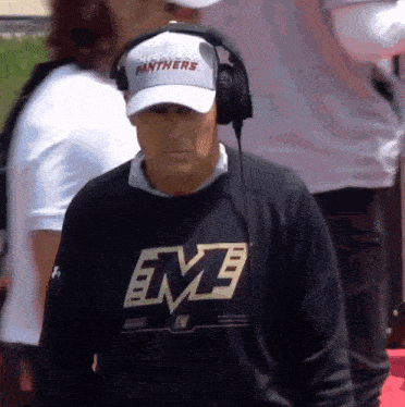 a man wearing headphones and a shirt that says eme on it