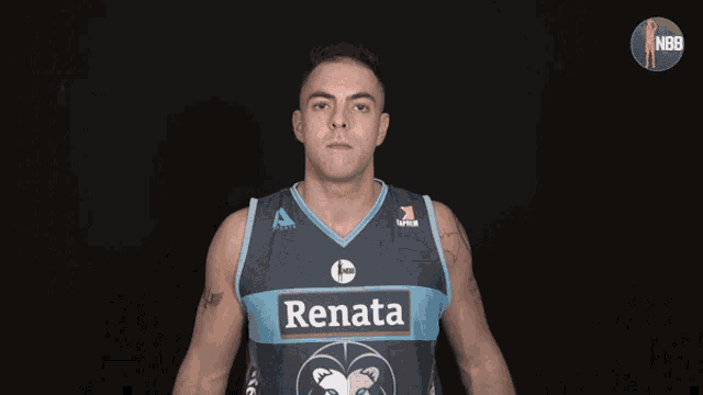 a man wearing a renata jersey stands in front of a black background