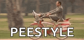 a man in a suit is riding a bicycle with his feet up in the air .