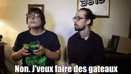two men playing a video game with the words non j'veux faire des gateaux below them