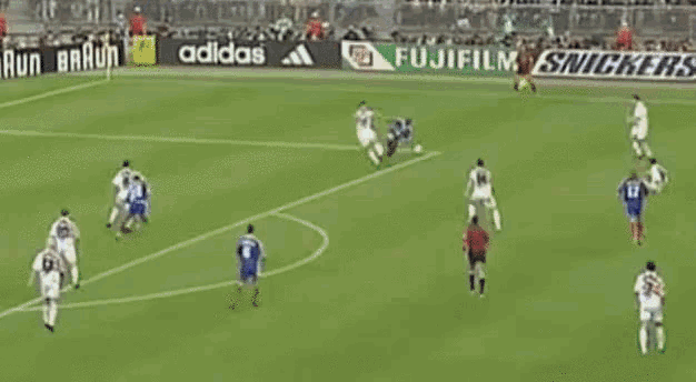 a soccer goalie is diving to catch a ball in front of a banner for gillette