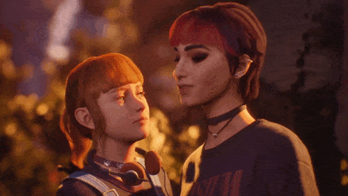 a couple of girls looking at each other with one wearing a black shirt that says ' nirvana ' on it