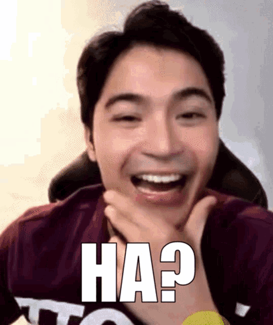 a man is making a funny face and has the word ha written on his chest