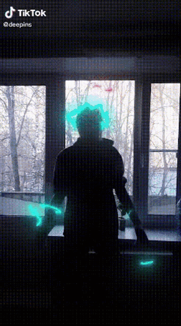 a man is standing in front of a window with a green light coming out of his head