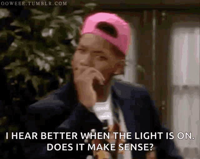 a man wearing a pink hat says i hear better when the light is on