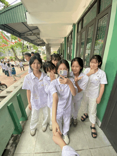 a girl taking a picture of herself with a cell phone