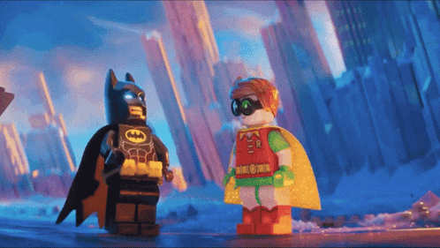 lego batman and robin are standing next to each other in a city