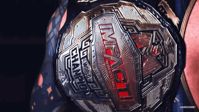 a close up of a wrestling belt that says impact