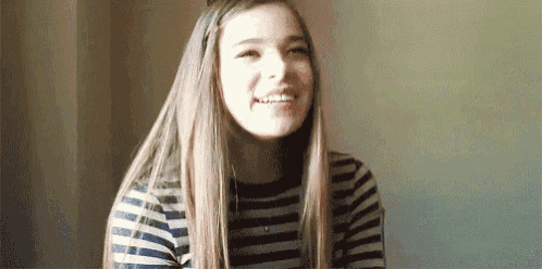 a girl with long hair is wearing a striped shirt