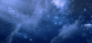 it looks like a galaxy with a lot of stars and clouds in the sky .