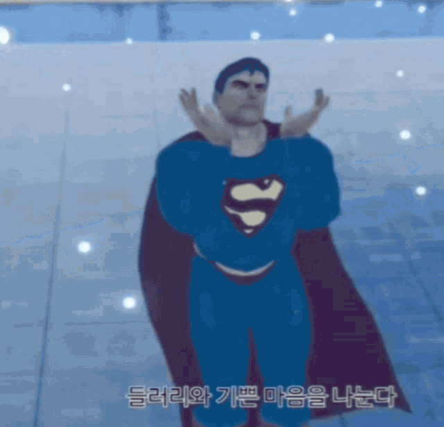 a man in a superman costume is standing in front of a blue background