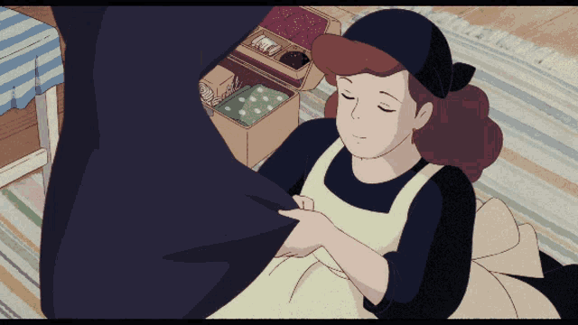 a woman in an apron is laying on a striped rug