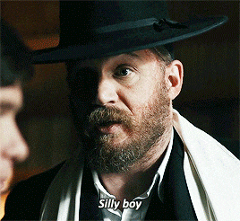 a man with a beard is wearing a hat and says silly boy