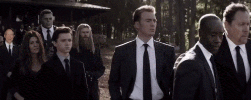 a group of men in suits and ties are standing next to each other in a line .