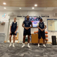 three men are standing in front of a sign that says tiktok on it