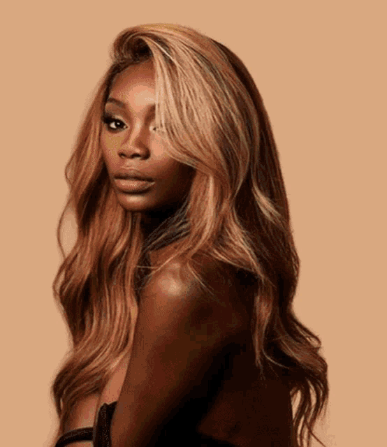 a woman with long brown hair is wearing a black dress