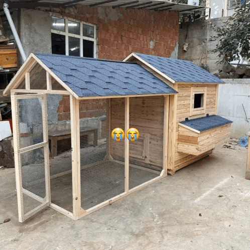 a wooden chicken coop with a blue roof and two crying faces on the door