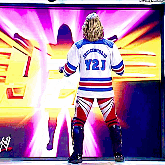 a wrestler in a jersey that says y2j