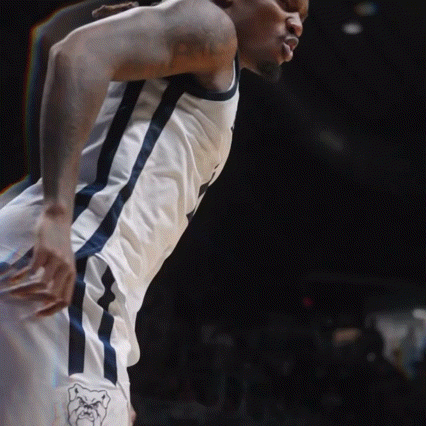 a basketball player with a tattoo on his arm is standing on the court