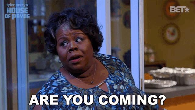 a woman says " are you coming " in front of a window