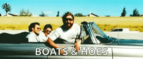 a man is sitting in a car with two other men .