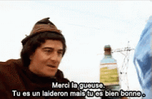 a man in a hat is talking to another man in french