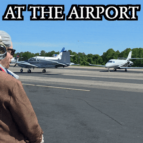 a man looking at a plane with the words at the airport written above it