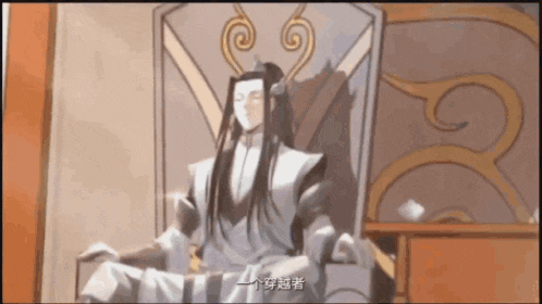 a man with long hair is sitting in a chair with chinese writing on the wall behind him