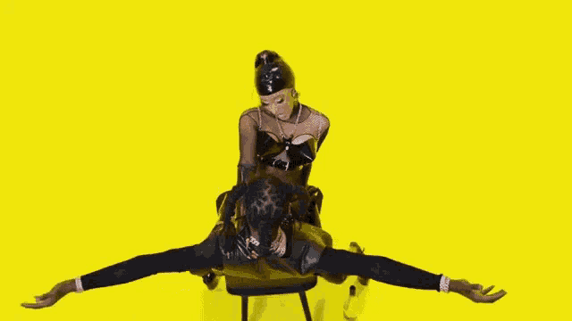 a woman is sitting on top of a man on a chair .