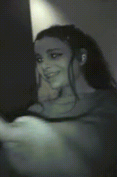 a black and white photo of a woman taking a picture of herself