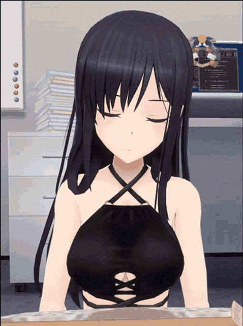 a girl in a black top is sitting in front of a desk