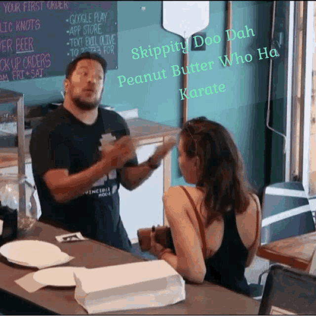 a man talking to a woman in front of a chalkboard that says skippy doo dah peanut butter who ha karate