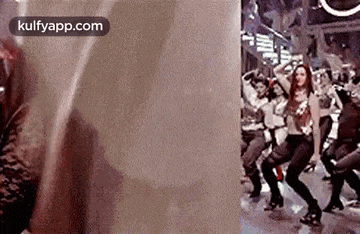 a group of people are dancing on a street in front of a building .