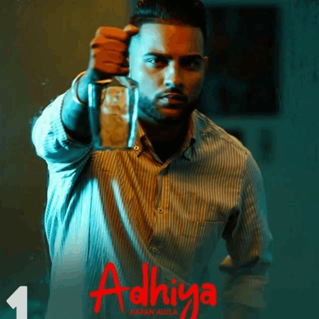 a poster for a movie called adhiya with a man holding a glass in his hand